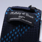 Holliday &amp; Brown - 100th Anniversary Collection
100%&nbsp;Woven Jacquard Silk
Tipped

Blue and Sky Blue motif tie
Handmade in Italy

7.5 cm x 148 cm
#10045