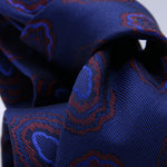 Holliday &amp; Brown - 100th Anniversary Collection
100%&nbsp;Woven Jacquard Silk
Tipped

Royal Blue and Rust motif tie
Handmade in Italy

7.5 cm x 148 cm
#10049