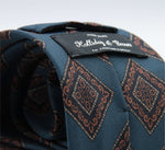 Holliday &amp; Brown for Cruciani &amp; Bella
100% printed Madder Silk
Self Tipped
Denim Blue, Brown, Dark Blue and Yellow motif Tie
Handmade in Italy
8 cm x 150 cm
#8955