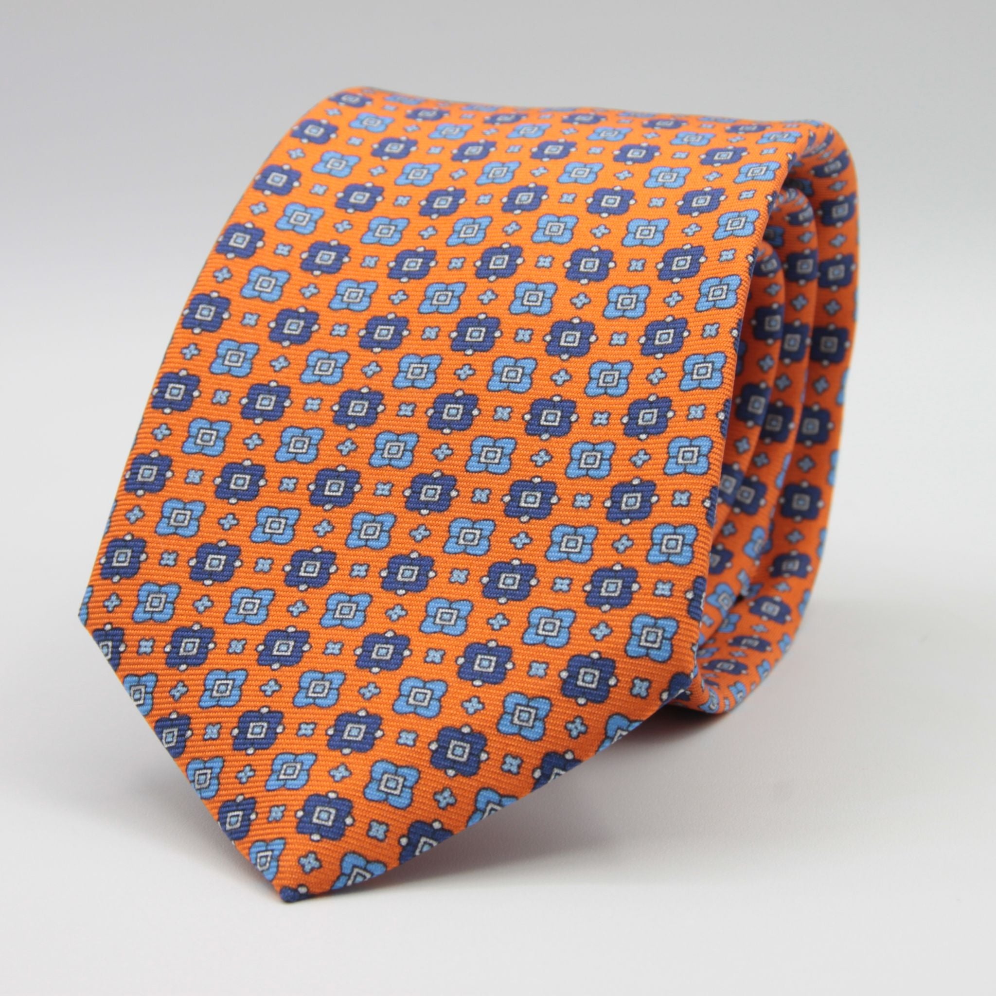Cruciani &amp; Bella
100% Printed Silk

Self-Tipped
Orange, Blue, Light Blue and White Motif Tie&nbsp;
Handmade in Rome, Italy.

8 cm x 150 cm
#9298