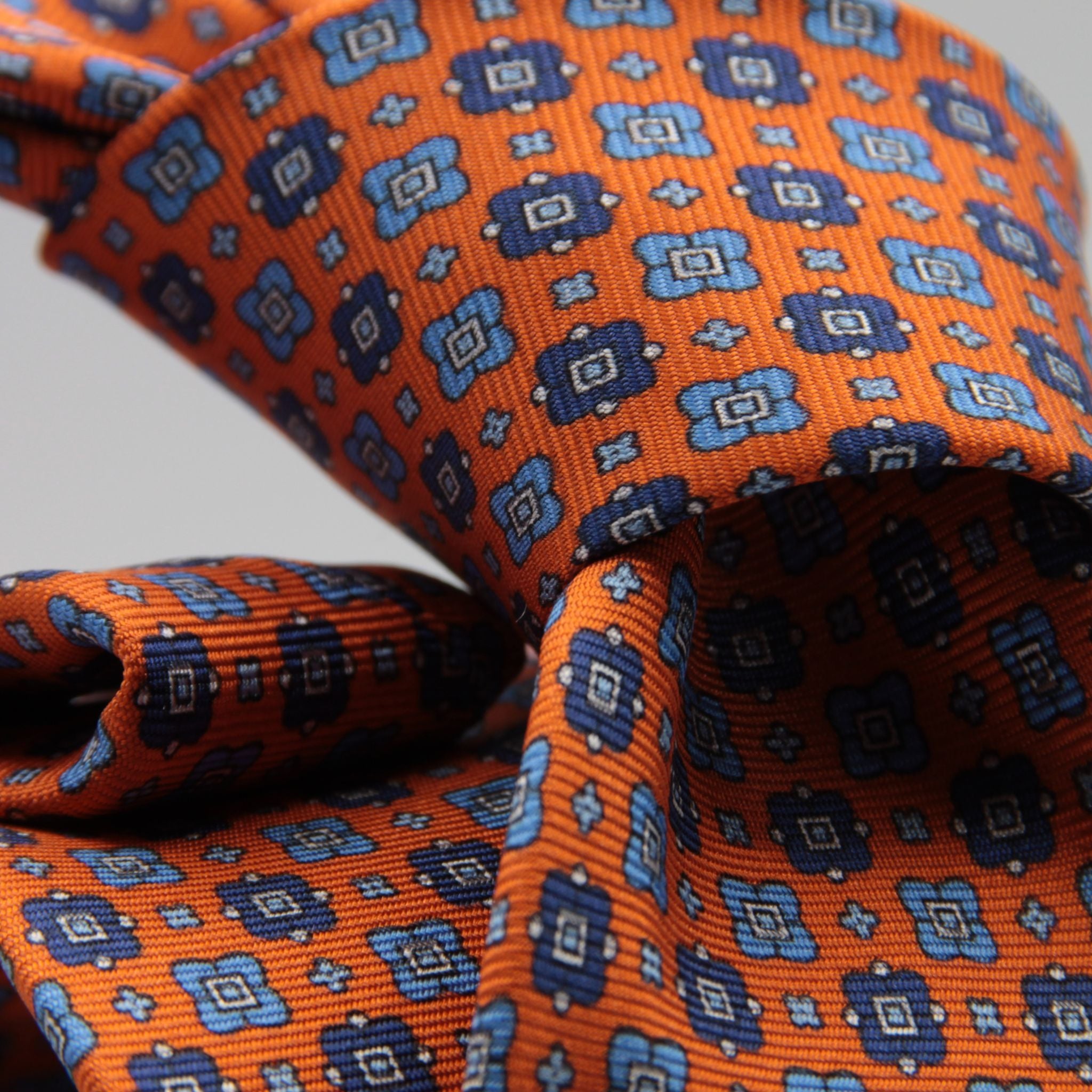 Cruciani &amp; Bella
100% Printed Silk

Self-Tipped
Orange, Blue, Light Blue and White Motif Tie&nbsp;
Handmade in Rome, Italy.

8 cm x 150 cm
#9298