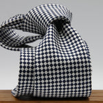 Cruciani &amp; Bella

100% Woven Jacquard Silk
Tipped
3-Folds High
White and dark Blue Optical Motif Tie
Handmade in Como, Italy
8 cm x 150 cm
#7877