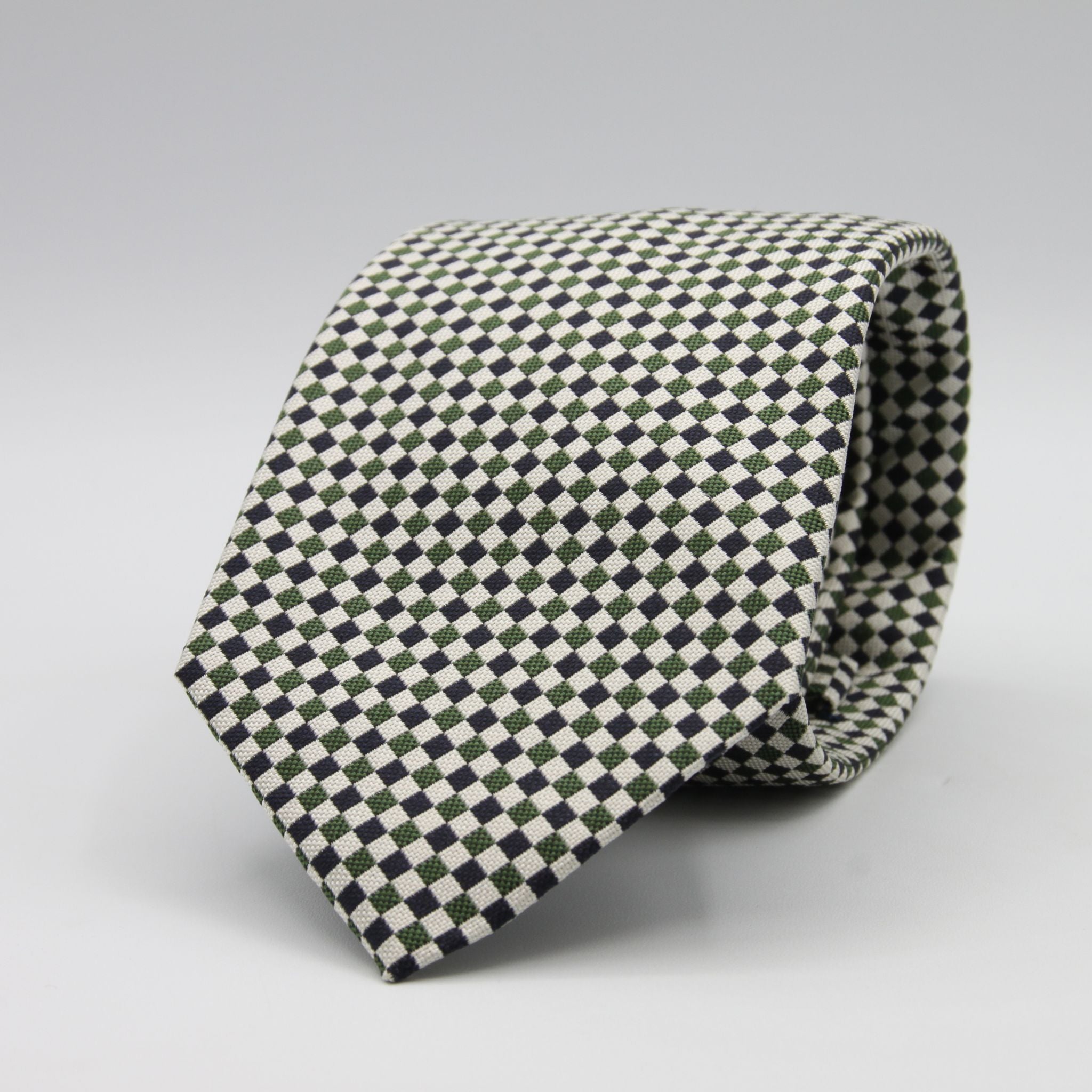 Cruciani &amp; Bella

100% Woven Jacquard silk
Tipped

Green, Off White and Blue Optical Motif Tie
Handmade in Como, Italy
8 cm x 150 cm
#8805
