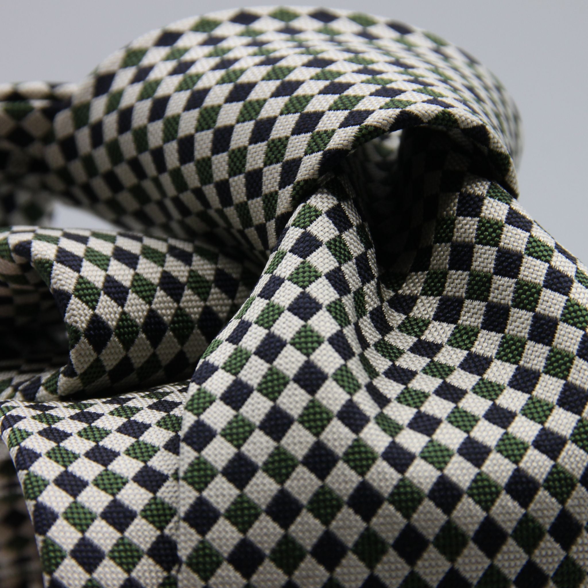 Cruciani &amp; Bella

100% Woven Jacquard silk
Tipped

Green, Off White and Blue Optical Motif Tie
Handmade in Como, Italy
8 cm x 150 cm
#8805