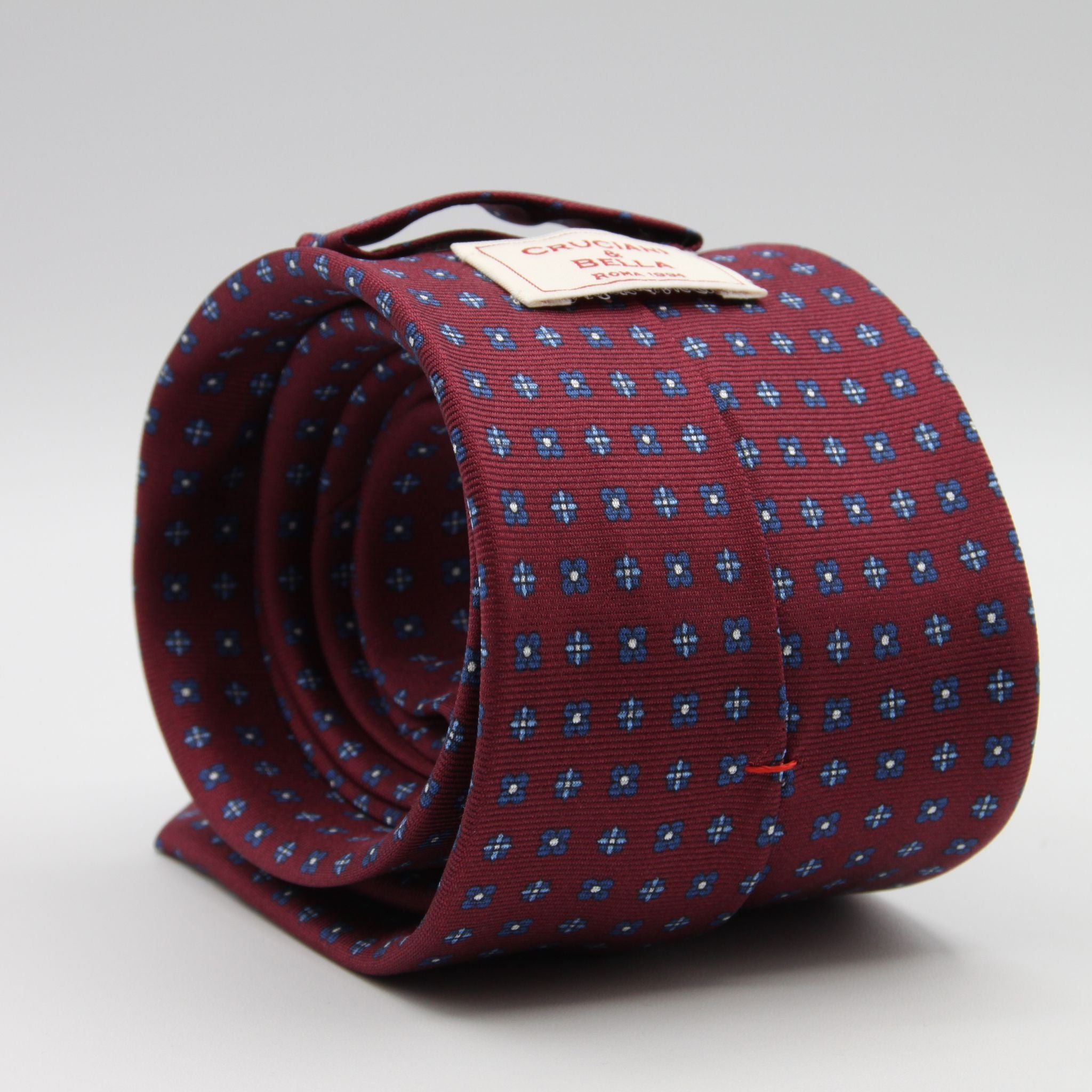 Cruciani &amp; Bella
100% Printed Silk

Self-Tipped
Red Wine, Blue, Light Blue and White Motif Tie&nbsp;
Handmade in Rome, Italy.

8 cm x 150 cm
#9304