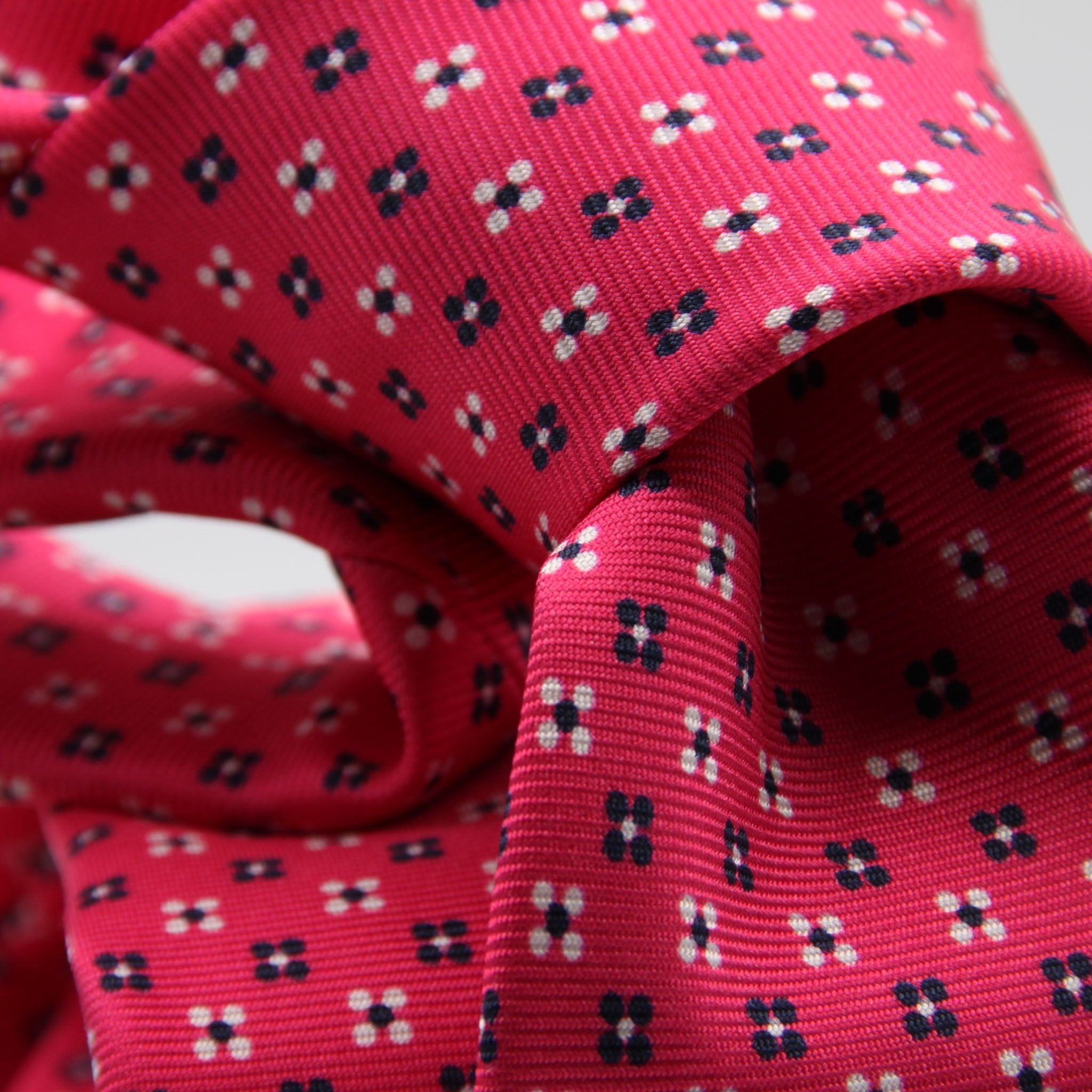 Cruciani &amp; Bella
100% Printed Silk

Self-Tipped
Fucsia, White and Blue Motif Tie
Handmade in Rome, Italy.
8 cm x 150 cm
#9427