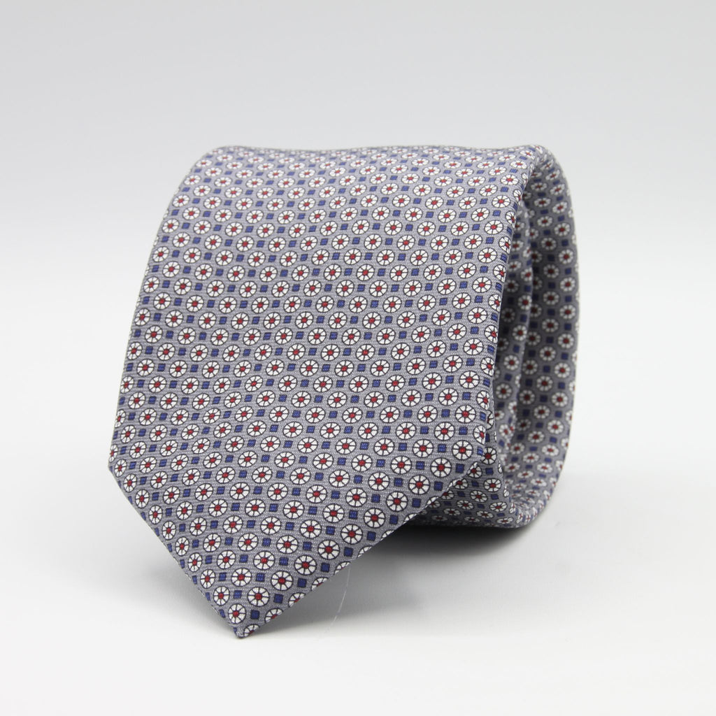 Cruciani &amp; Bella
100% Printed Silk

Self-Tipped
Grey, White, Red and Blue Motif Tie
Handmade in Rome, Italy.
8 cm x 150 cm
#9429