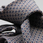 Cruciani &amp; Bella
100% Printed Silk

Self-Tipped
Grey, White, Red and Blue Motif Tie
Handmade in Rome, Italy.
8 cm x 150 cm
#9429