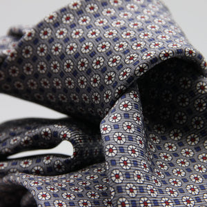 Cruciani &amp; Bella
100% Printed Silk

Self-Tipped
Grey, White, Red and Blue Motif Tie
Handmade in Rome, Italy.
8 cm x 150 cm
#9429