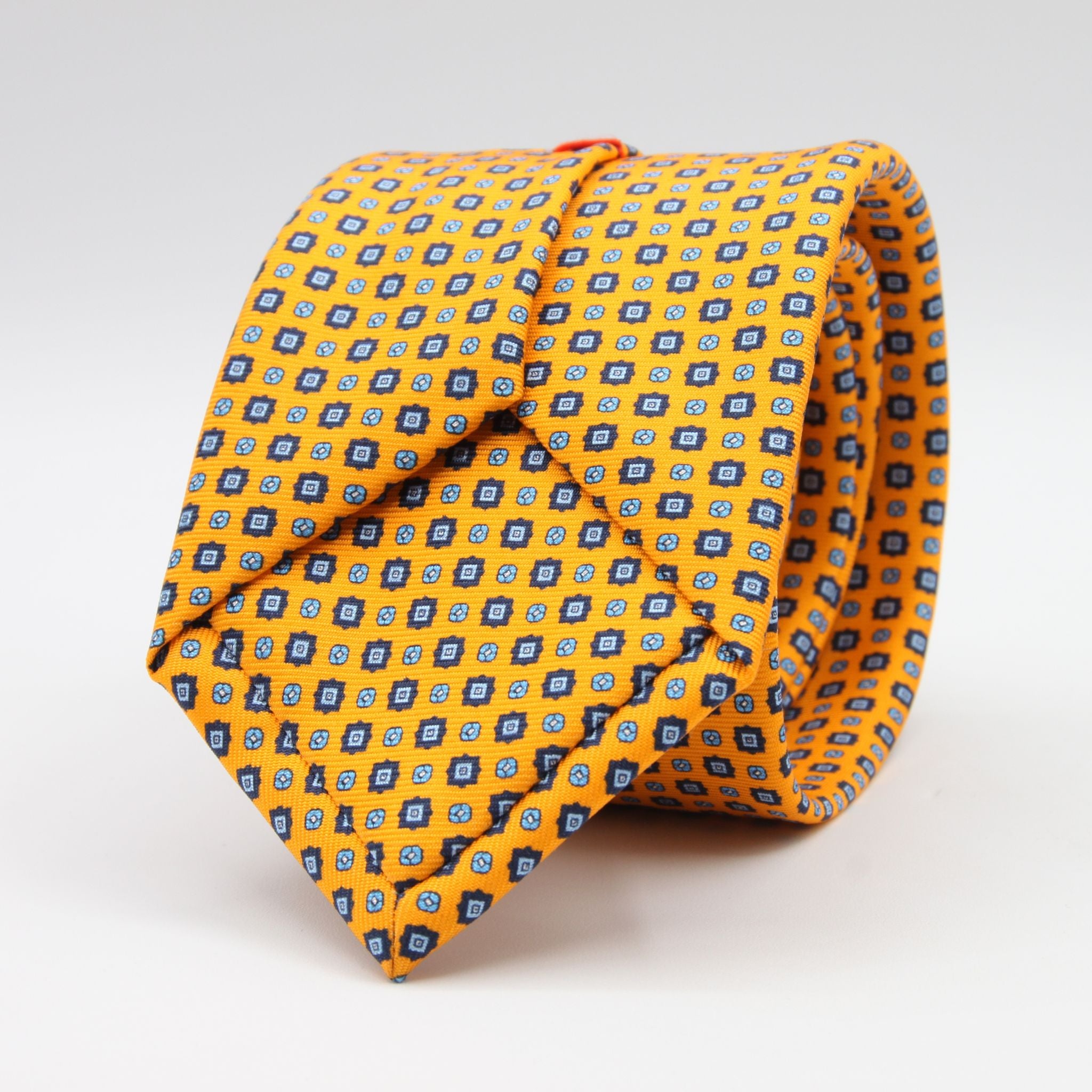 Cruciani &amp; Bella
100% Printed Silk

Self-Tipped
Light Orange, Royal Blue and Light Blue Motif Tie
Handmade in Rome, Italy.
8 cm x 150 cm
#9432