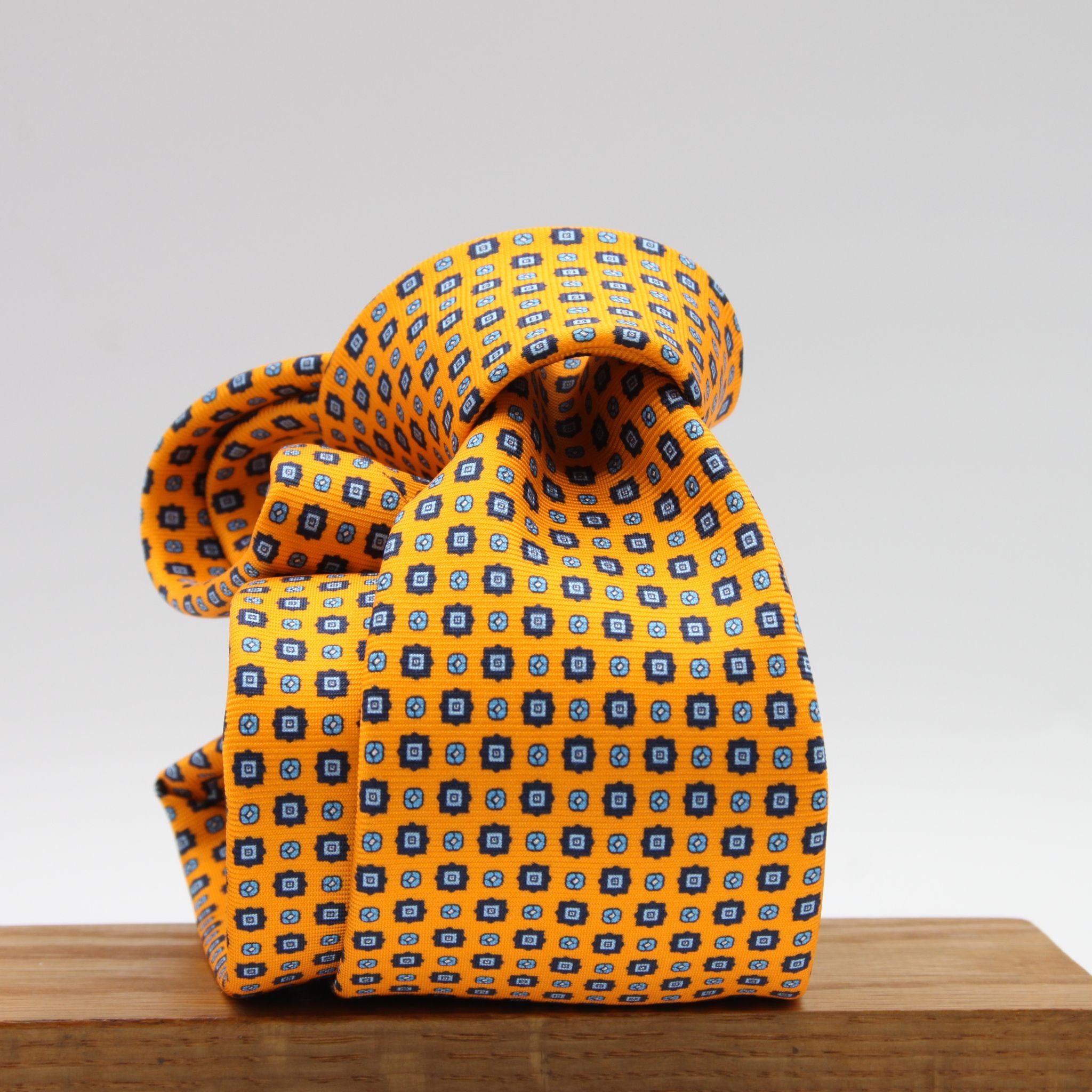 Cruciani &amp; Bella
100% Printed Silk

Self-Tipped
Light Orange, Royal Blue and Light Blue Motif Tie
Handmade in Rome, Italy.
8 cm x 150 cm
#9432