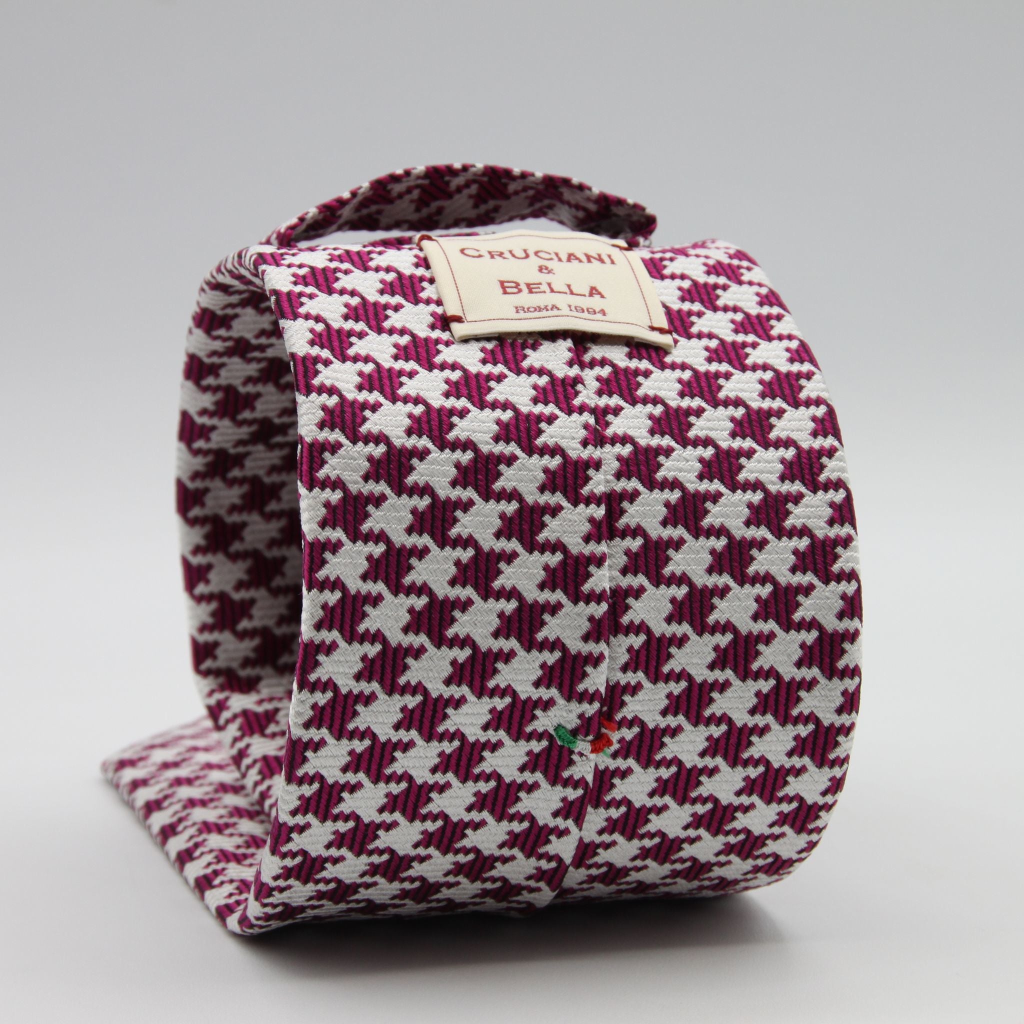 Cruciani &amp; Bella

100% Woven Jacquard silk
Tipped

Fuchsia Houndstooth Tie
Handmade in Como, Italy
8 cm x 150 cm
#7723