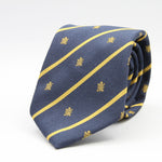 Cruciani &amp; Bella per Gentlemen Drivers
100% Woven Jacquard Silk
Tipped
Blue, Gold Stripes Crest Tie
Handmade in Italy
8 cm x 150 cm
#9204