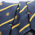 Cruciani &amp; Bella per Gentlemen Drivers
100% Woven Jacquard Silk
Tipped
Blue, Gold Stripes Crest Tie
Handmade in Italy
8 cm x 150 cm
#9204