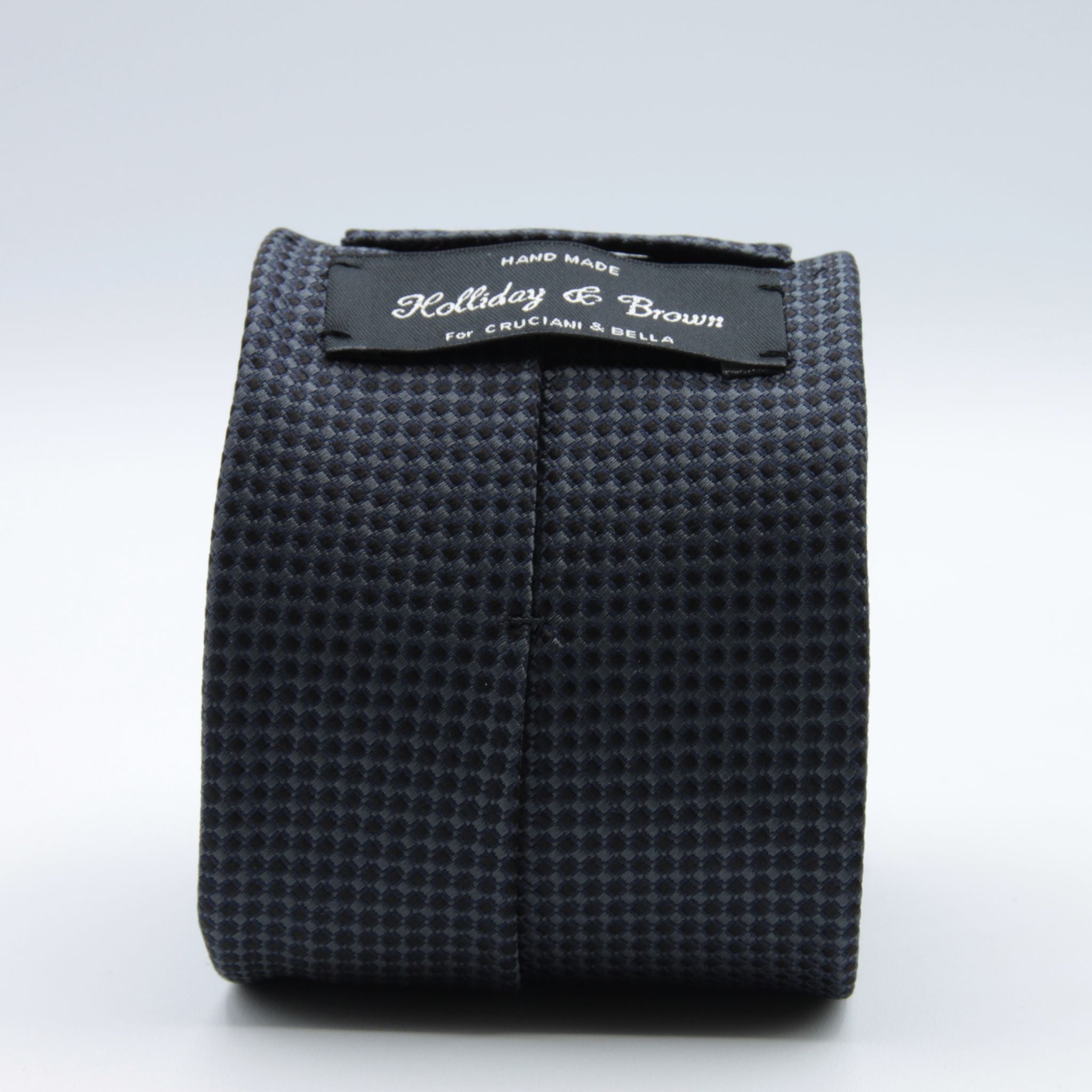 Holliday &amp; Brown for Cruciani &amp; Bella
100%&nbsp;Woven Jacquard Silk
Tipped

Grey, Dark Blue and Black motif tie
Handmade in Italy

8 cm x 150 cm
#8968
