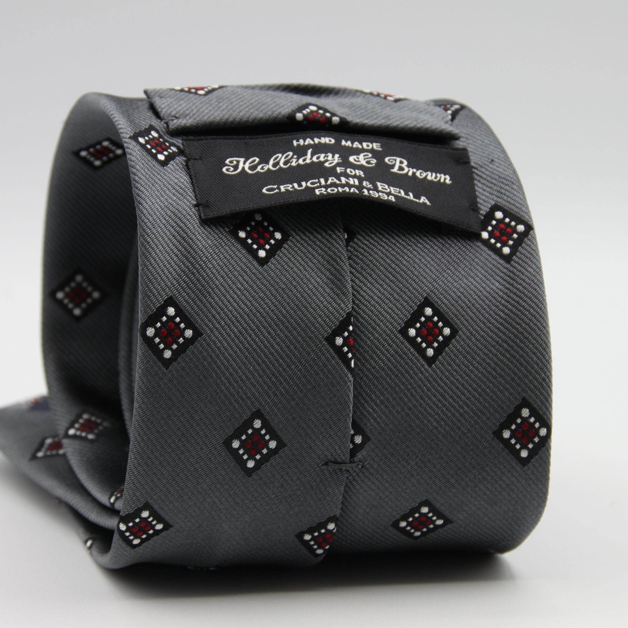 Holliday &amp; Brown for Cruciani &amp; Bella
100%&nbsp;Woven Jacquard Silk
Tipped

Grey, White and Red color motif tie
Handmade in Italy

8 cm x 150 cm
#9342