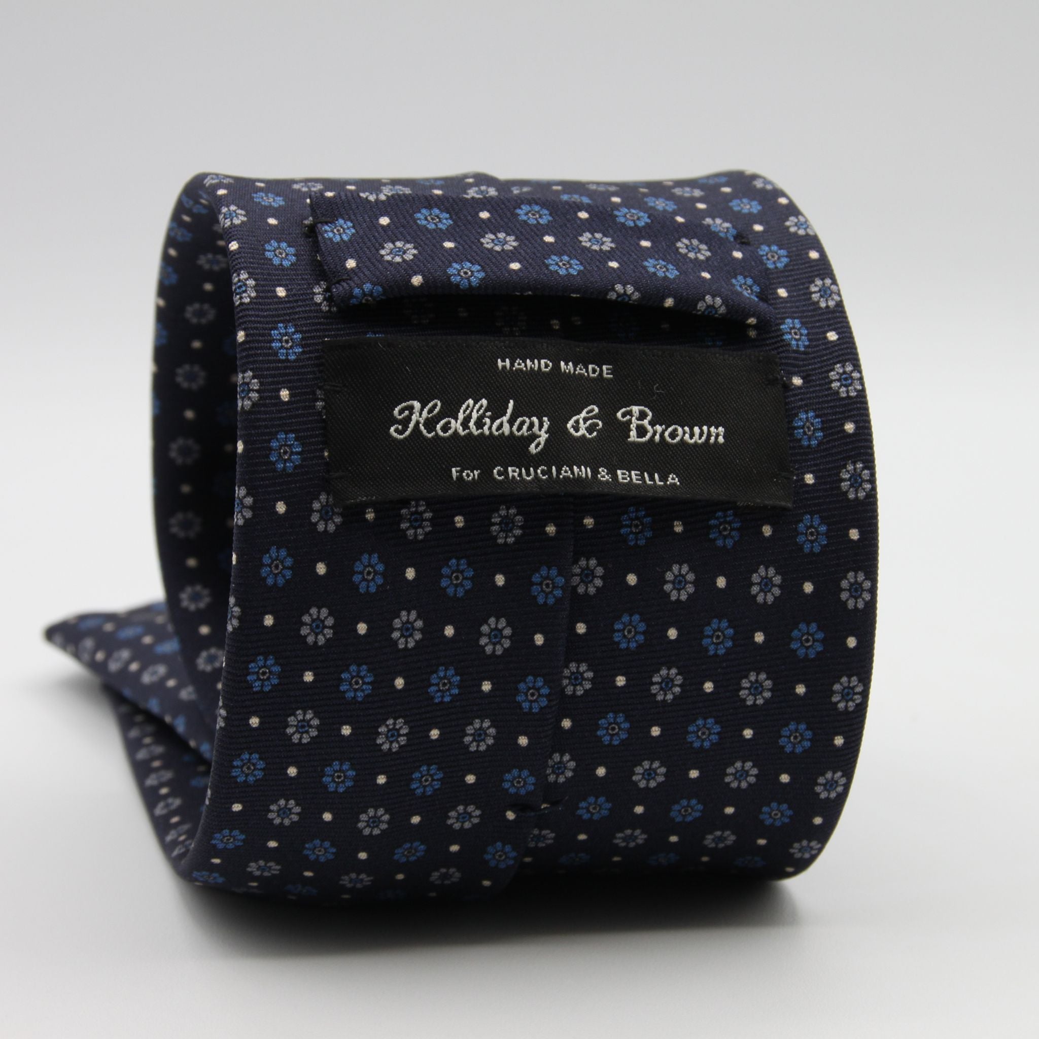 Holliday &amp; Brown for Cruciani &amp; Bella
100% Printed Silk
Self Tipped
Dark Blue, Light Blue, Grey and Fuchsia motif Tie
Handmade in Italy
8 cm x 150 cm
#9360