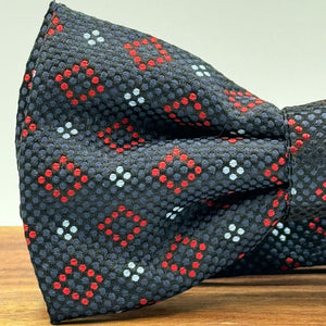 <ul> <li>Cruciani &amp; Bella Bow Tie</li> <li>100% Woven Silk Jacquard Made in England</li> <li>Handmade in Italy</li> <li>Navy Blue, Red and Light Blue motif</li> <li>Handcrafted in Italy</li> <li>Coated metal Labels</li> <li>Bow Ties</li> </ul>