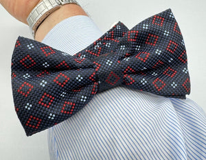 <ul> <li>Cruciani &amp; Bella Bow Tie</li> <li>100% Woven Silk Jacquard Made in England</li> <li>Handmade in Italy</li> <li>Navy Blue, Red and Light Blue motif</li> <li>Handcrafted in Italy</li> <li>Coated metal Labels</li> <li>Bow Ties</li> </ul>