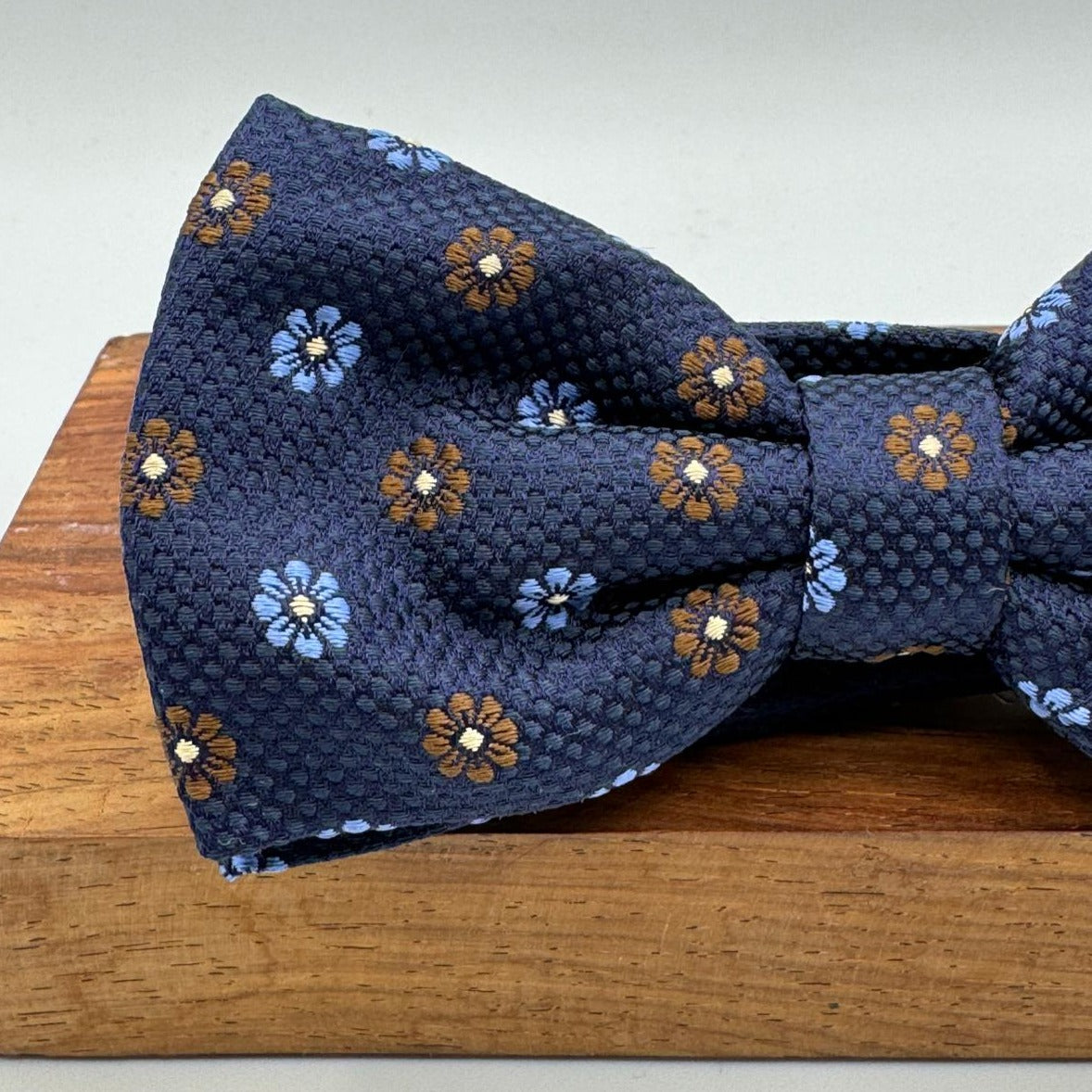 <ul> <li>Cruciani &amp; Bella Bow Tie</li> <li>100% Woven Silk Jacquard Made in England</li> <li>Handmade in Italy</li> <li>Navy Blue, Brown and Light Blue motif</li> <li>Handcrafted in Italy</li> <li>Coated metal Labels</li> <li>Bow Ties</li> </ul>