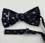 <ul> <li>Cruciani &amp; Bella Bow Tie</li> <li>100% Woven Silk Jacquard Made in England</li> <li>Handmade in Italy</li> <li>Navy Blue, Brown and Light Violet motif</li> <li>Handcrafted in Italy</li> <li>Coated metal Labels</li> <li>Bow Ties</li> </ul>