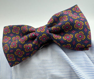 <ul> <li>Cruciani &amp; Bella Bow Tie</li> <li>100% Printed Silk Made in England</li> <li>Handmade in Italy</li> <li>Blue,Red, Orange and Light Blue motif</li> <li>Handcrafted in Italy</li> <li>Coated metal Labels</li> <li>Bow Ties</li> </ul>