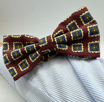 <ul> <li>Cruciani &amp; Bella Bow Tie</li> <li>100% Printed Madder Silk&nbsp;</li> <li>Handmade in Italy</li> <li>Red Wine, Light Blue, Brown and Cream motif</li> <li>Handcrafted in Italy</li> <li>Coated metal Labels</li> <li>Bow Ties</li> </ul>