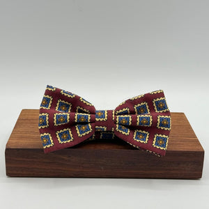 <ul> <li>Cruciani &amp; Bella Bow Tie</li> <li>100% Printed Madder Silk&nbsp;</li> <li>Handmade in Italy</li> <li>Red Wine, Light Blue, Brown and Cream motif</li> <li>Handcrafted in Italy</li> <li>Coated metal Labels</li> <li>Bow Ties</li> </ul>