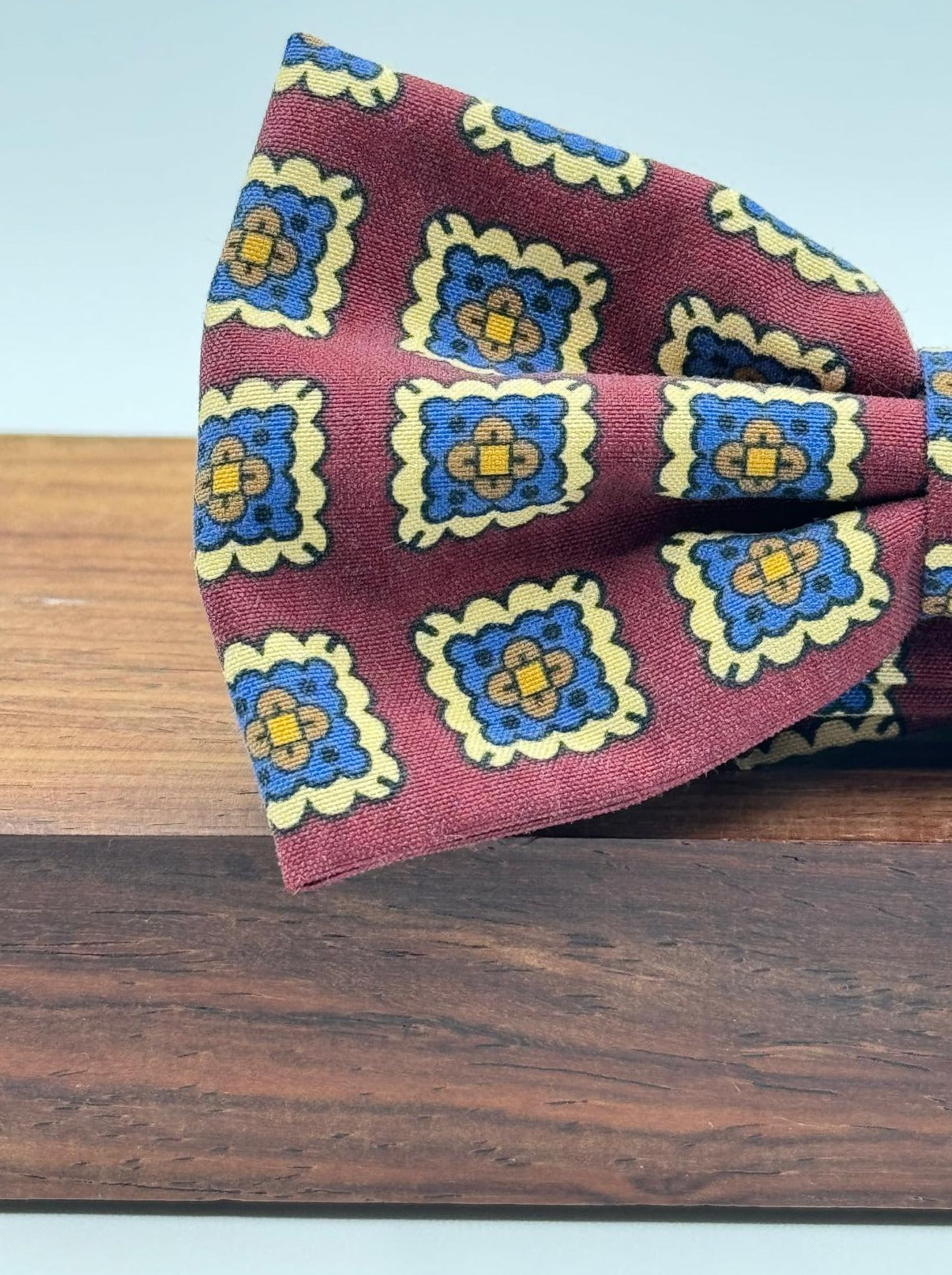 <ul> <li>Cruciani &amp; Bella Bow Tie</li> <li>100% Printed Madder Silk&nbsp;</li> <li>Handmade in Italy</li> <li>Red Wine, Light Blue, Brown and Cream motif</li> <li>Handcrafted in Italy</li> <li>Coated metal Labels</li> <li>Bow Ties</li> </ul>