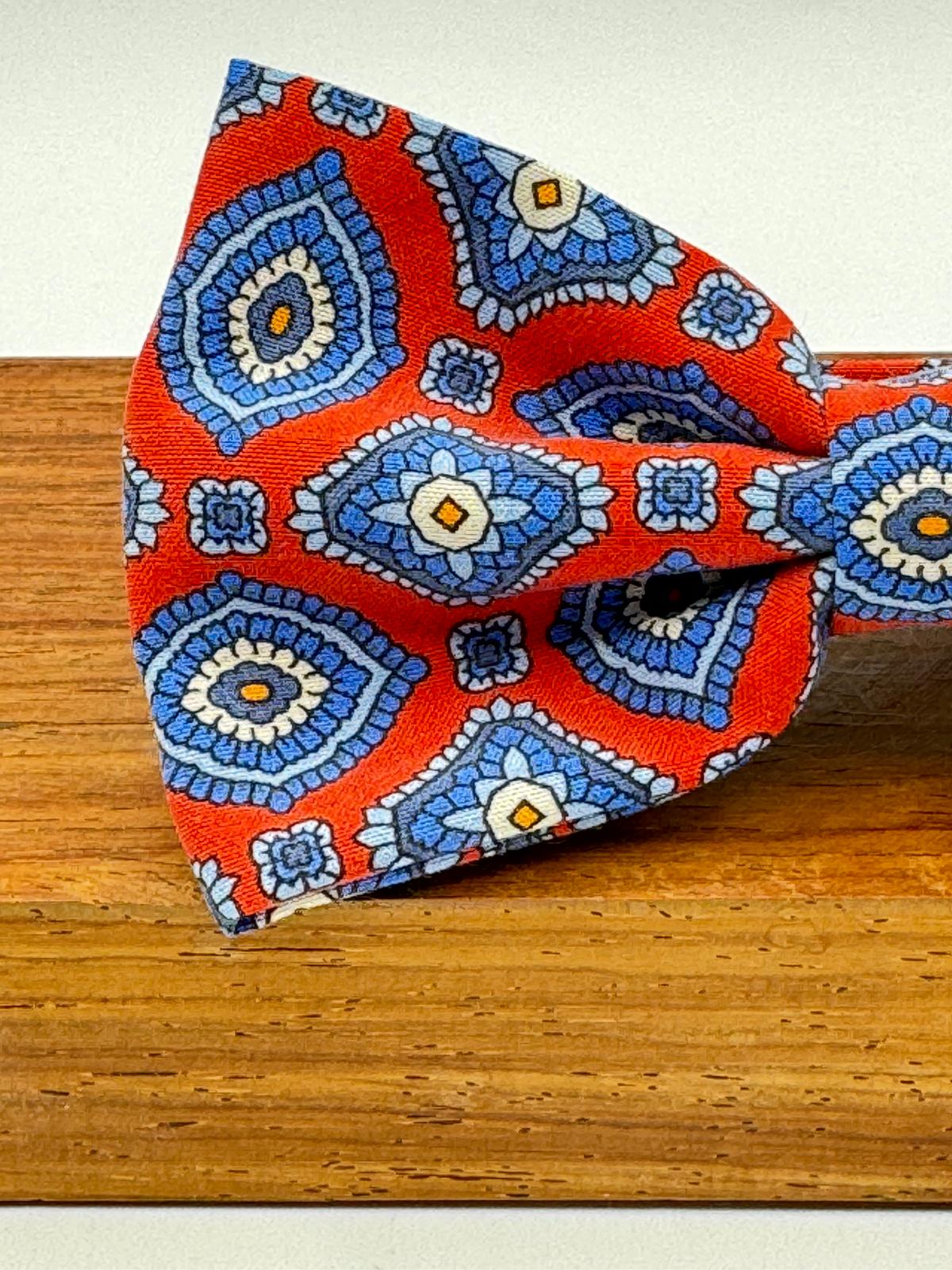 <ul> <li>Cruciani &amp; Bella Bow Tie</li> <li>100% Printed Madder Silk&nbsp;</li> <li>Handmade in Italy</li> <li>Red, Blue, Beige, Light Blue and Orange motif&nbsp;&nbsp;</li> <li>Handcrafted in Italy</li> <li>Coated metal Labels</li> <li>Bow Tie</li> </ul>