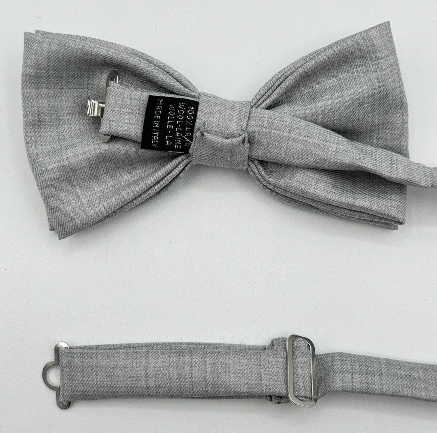 <ul> <li>Cruciani &amp; Bella Bow Tie</li> <li>100% Wool Holland &amp; Sherry</li> <li>Handmade in Italy</li> <li>Light Grey Plain</li> <li>Handcrafted in Italy</li> <li>Coated metal Labels</li> <li>Bow Ties</li> </ul>