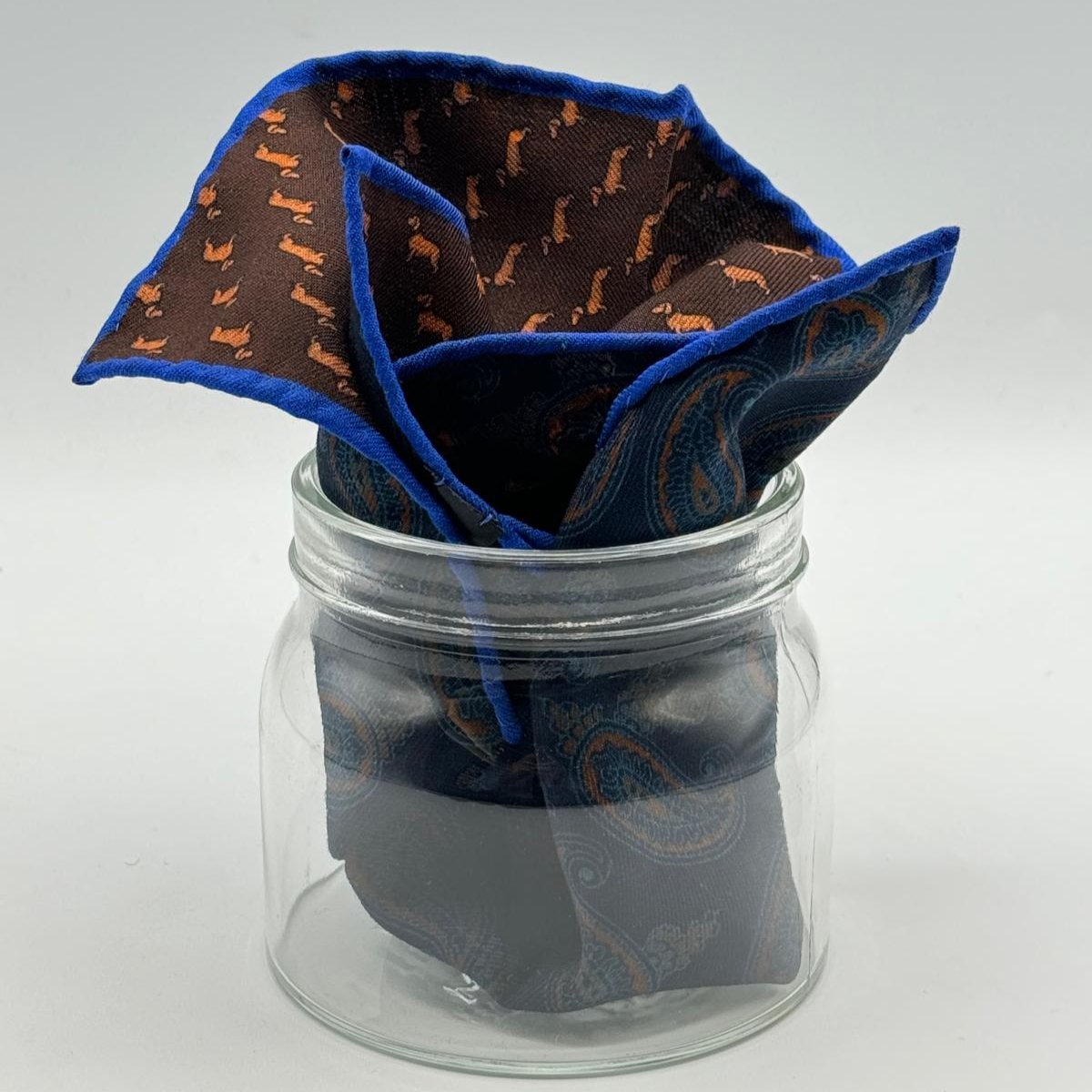 Cruciani &amp; Bella
Hand-rolled&nbsp;&nbsp;

100% Wool
Brown, Brick, Olimpic Blue
Double Faces
Basset Hound and Paisley Motif&nbsp; Pocket Square
Handmade in Italy

33 cm X 33 cm
