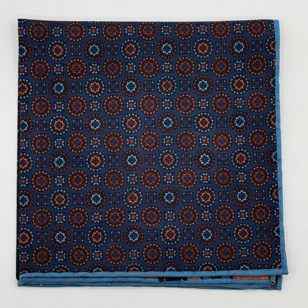 Cruciani &amp; Bella
Hand-rolled&nbsp;&nbsp;
100% Madder Silk
Denim Blue, Orange, Brown and Light Blue
Motif Pocket Square
Double Faces
Made in Italy
33 cm X 33 cm