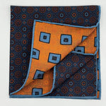 Cruciani &amp; Bella
Hand-rolled&nbsp;&nbsp;
100% Madder Silk
Denim Blue, Orange, Brown and Light Blue
Motif Pocket Square
Double Faces
Made in Italy
33 cm X 33 cm