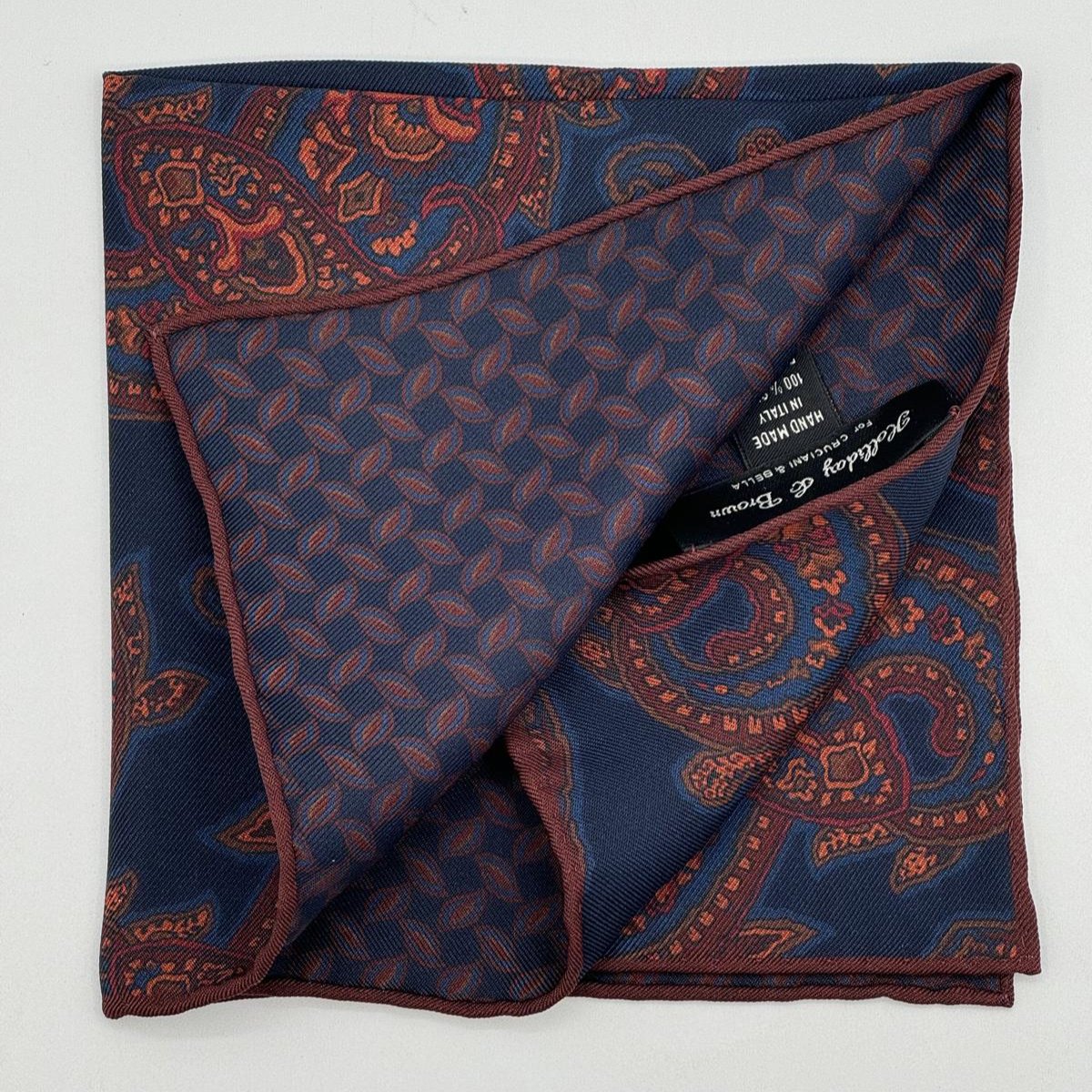 Holliday &amp; Brown for Cruciani &amp; Bella
Hand-rolled&nbsp;&nbsp;

100% Silk
Blue, Rust, Brown, Olimpic Blue,&nbsp;
Double Faces
Motif&nbsp; Pocket Square
Handmade in Italy

32 cm X 32 cm