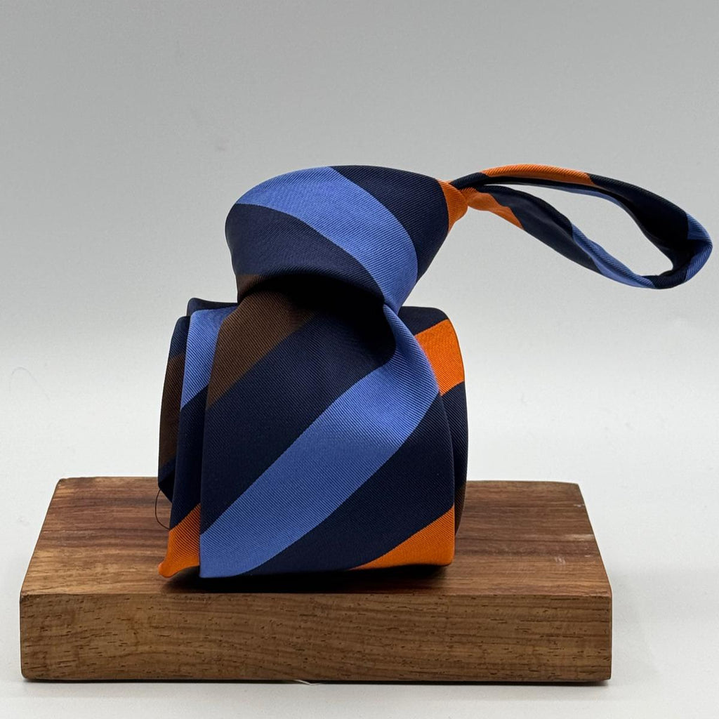 Cruciani &amp; Bella
50% Silk 50% Cotton

Tipped Tie
Blue, Light Blue, Brown, Orange and Light Blue Stripes
Handmade in Italy
8 cm x 148 cm
New Old Stock