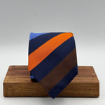 Cruciani &amp; Bella
50% Silk 50% Cotton

Tipped Tie
Blue, Light Blue, Brown, Orange and Light Blue Stripes
Handmade in Italy
8 cm x 148 cm
New Old Stock