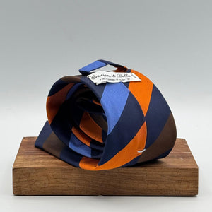 Cruciani &amp; Bella
50% Silk 50% Cotton

Tipped Tie
Blue, Light Blue, Brown, Orange and Light Blue Stripes
Handmade in Italy
8 cm x 148 cm
New Old Stock