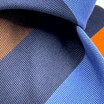 Cruciani &amp; Bella
50% Silk 50% Cotton

Tipped Tie
Blue, Light Blue, Brown, Orange and Light Blue Stripes
Handmade in Italy
8 cm x 148 cm
New Old Stock