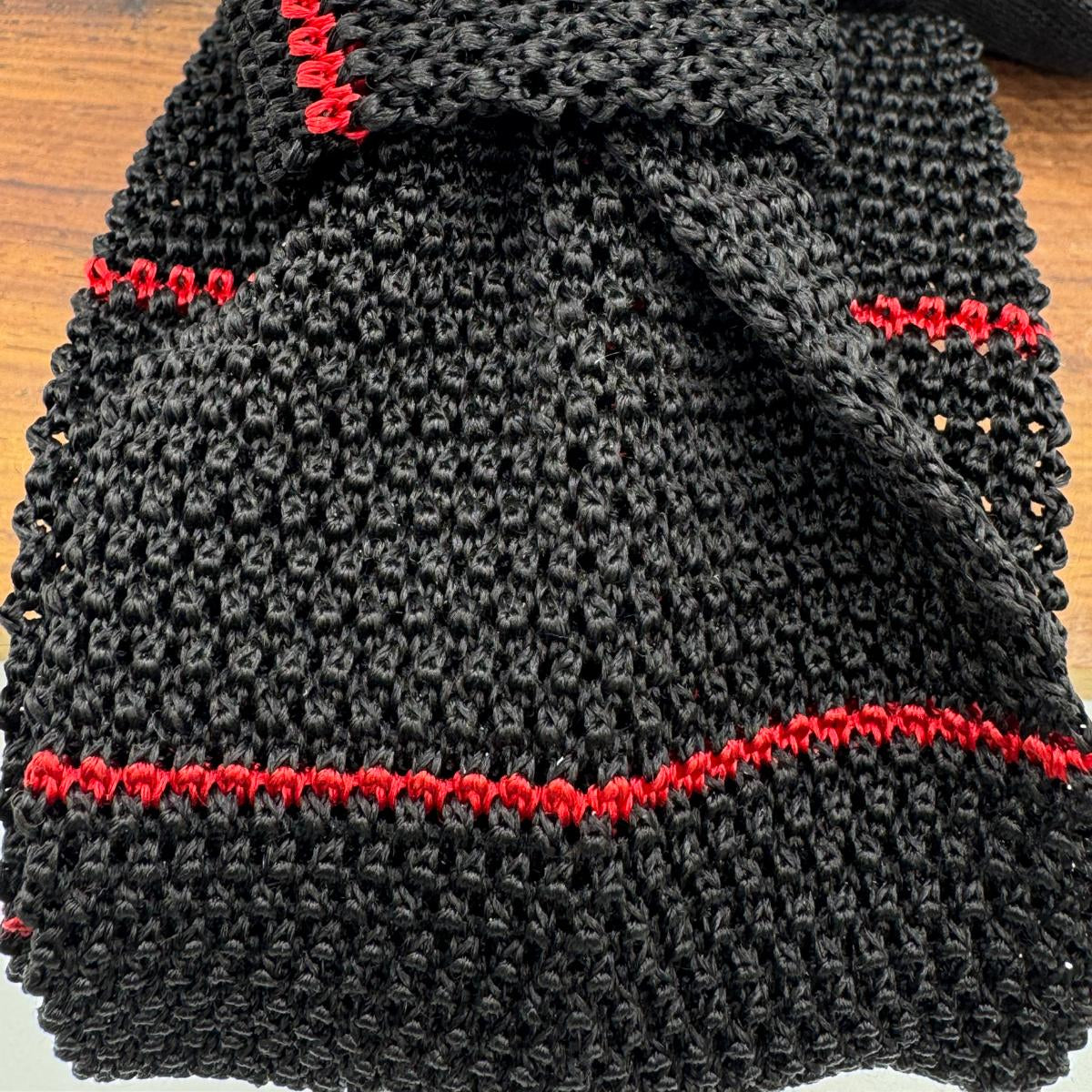 Cruciani &amp; Bella
100% Silk
Knitted Tie

Black, Red Stripe
Handmade in Italy
7,5 cm x 147 cm
New Old Stock