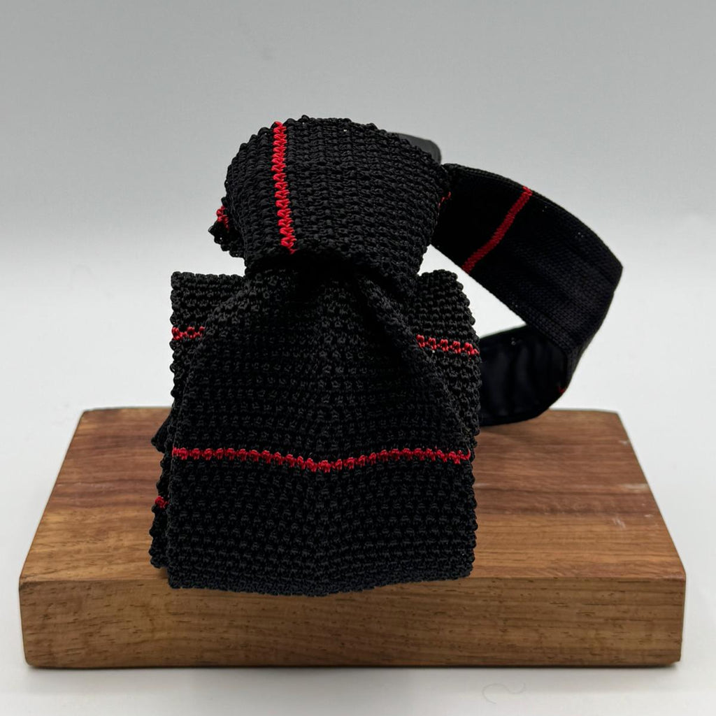 Cruciani &amp; Bella
100% Silk
Knitted Tie

Black, Red Stripe
Handmade in Italy
7,5 cm x 147 cm
New Old Stock