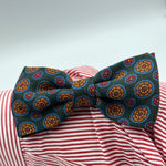 Cruciani &amp; Bella Bow Tie
85% Silk and 15 % Wool Made in England
Handmade in Italy
Green, Red, Orange, Light Blue and Yellow motif
Coated metal Labels
Bow Ties