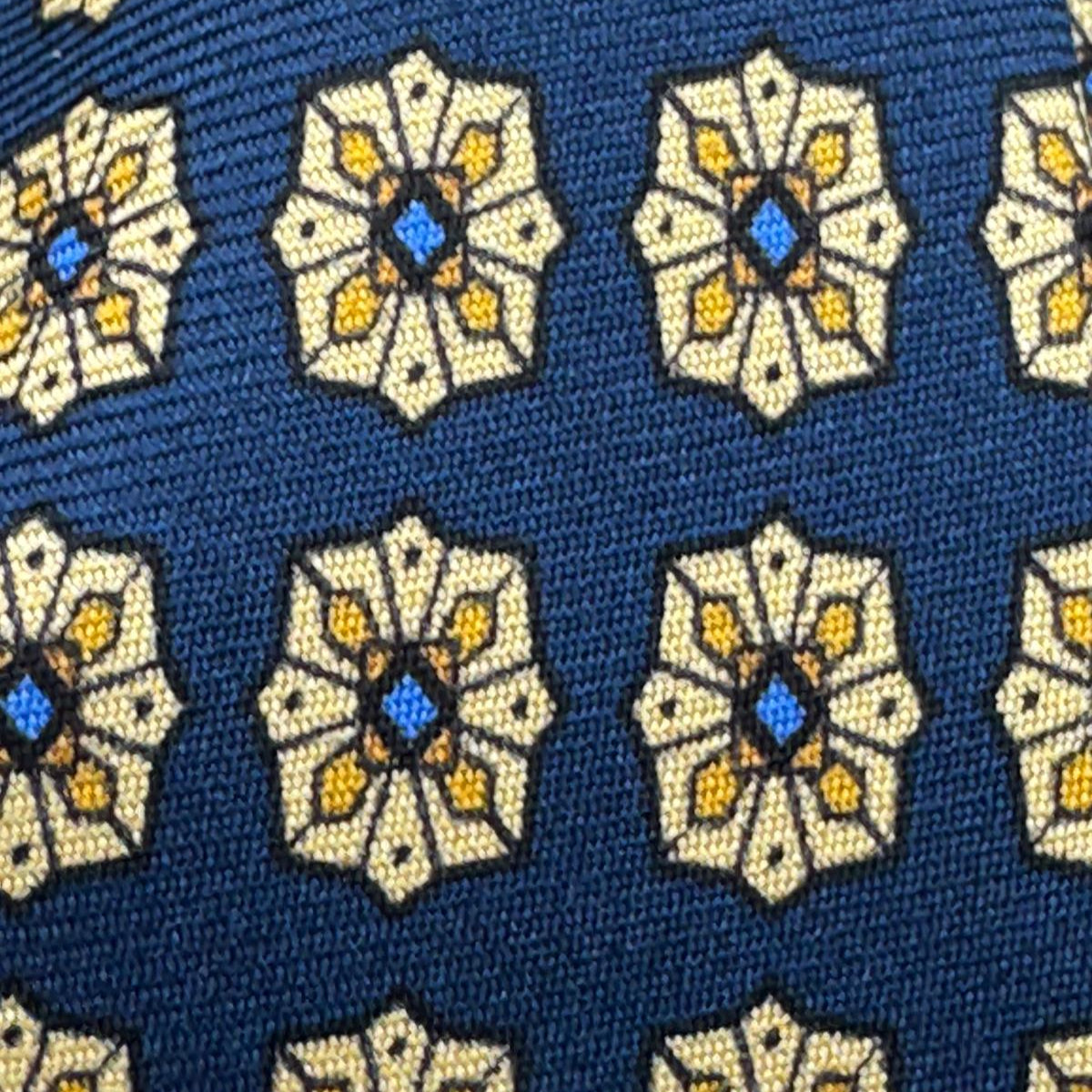 Cruciani &amp; Bella
100% Printed Silk&nbsp;
Tipped
Blue, Beige, Yellow and Light Blue Motif Tie
Handmade in Italy
8,5 cm x 148 cm
New Old Stock