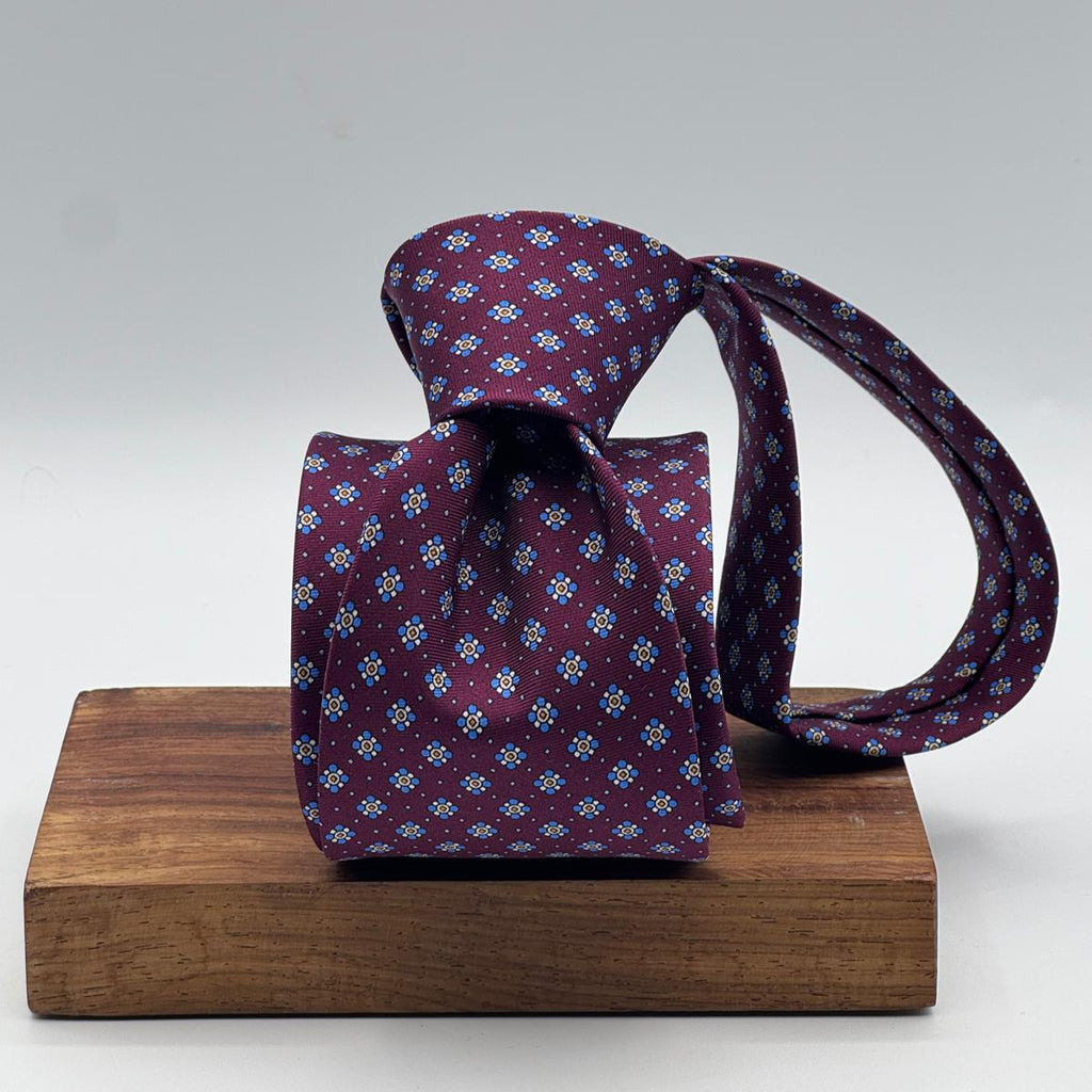 Cruciani &amp; Bella
100% Printed Silk&nbsp;
Tipped
Red Wine, Light Blue, Blue, Yellow and White Motif Tie
Handmade in Italy
8,5 cm x 148 cm
New Old Stock