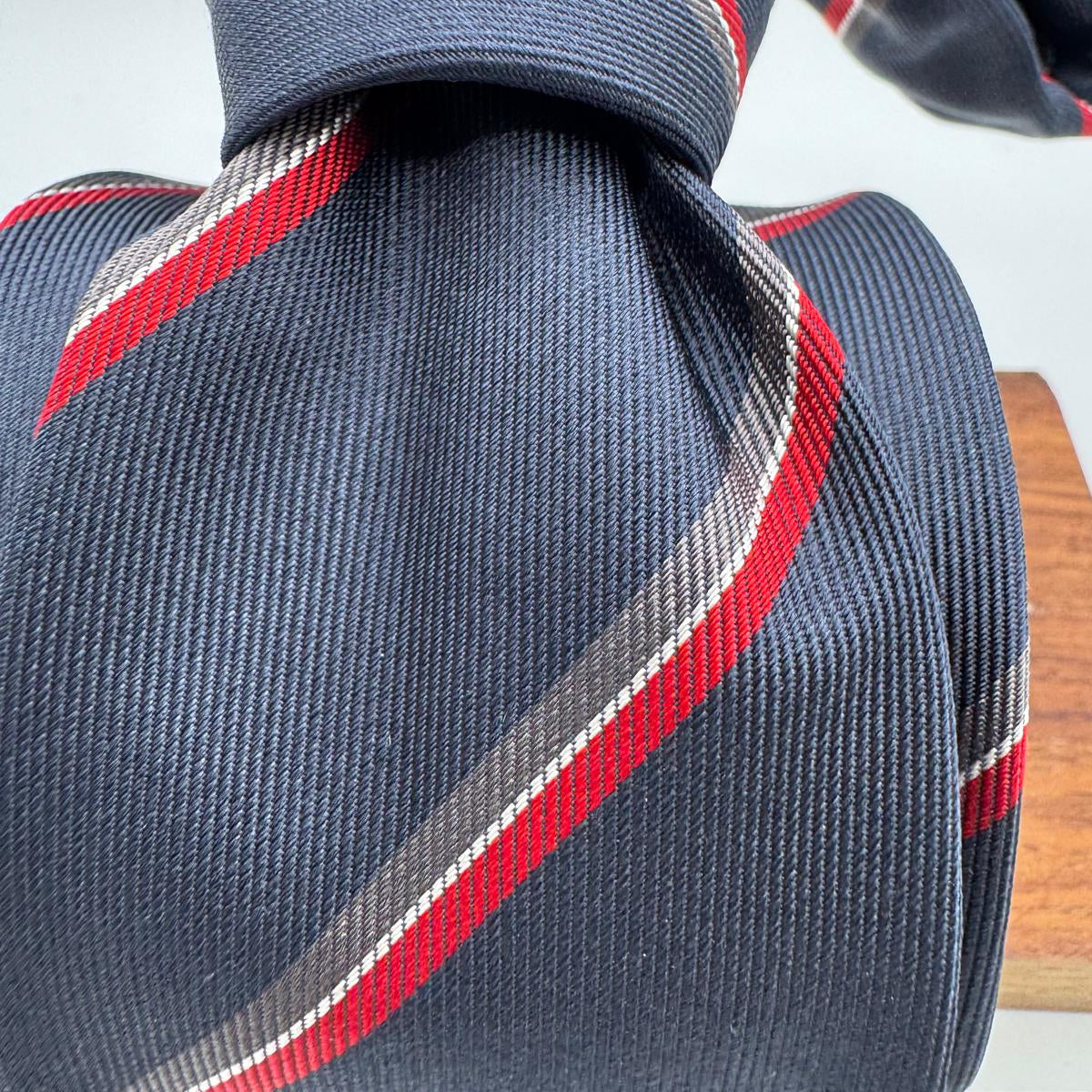 Cruciani &amp; Bella
100% Woven Silk&nbsp;

Crazy Regimental Tie
Tipped&nbsp;
Blue, Grey, Red and White Stripes

Handmade in Italy
8,5 cm x 148 cm
New Old Stock