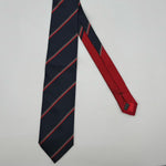 Cruciani &amp; Bella
100% Woven Silk&nbsp;

Crazy Regimental Tie
Tipped&nbsp;
Blue, Grey, Red and White Stripes

Handmade in Italy
8,5 cm x 148 cm
New Old Stock