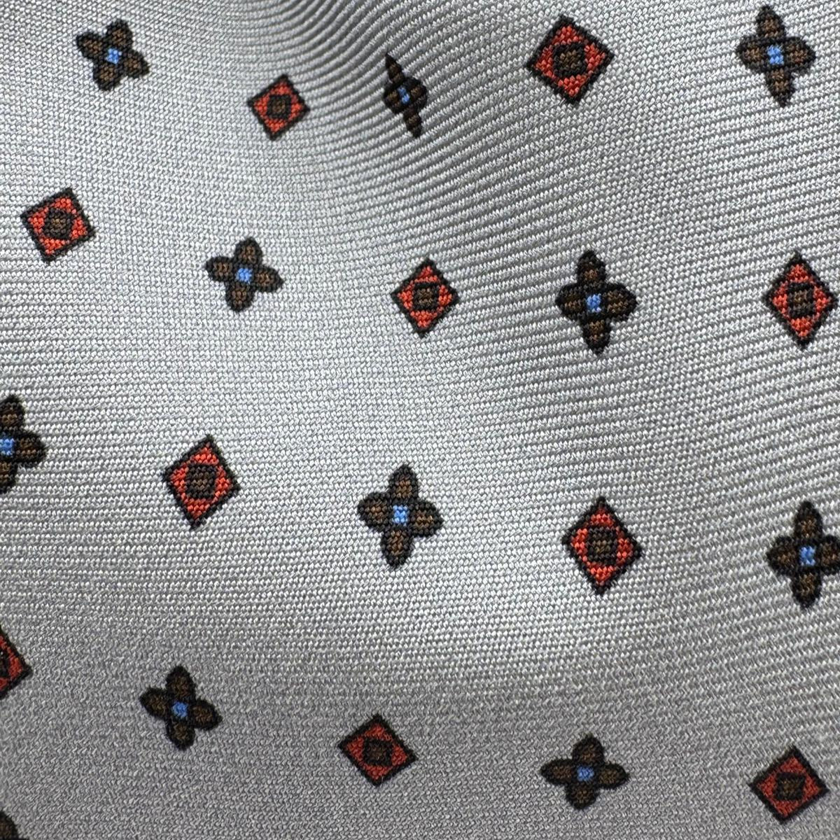 Cruciani &amp; Bella
100% Printed Silk&nbsp;
Tipped
Grey, Red and Blue Motif Tie
Handmade in Italy
8 cm x 148 cm
New Old Stock