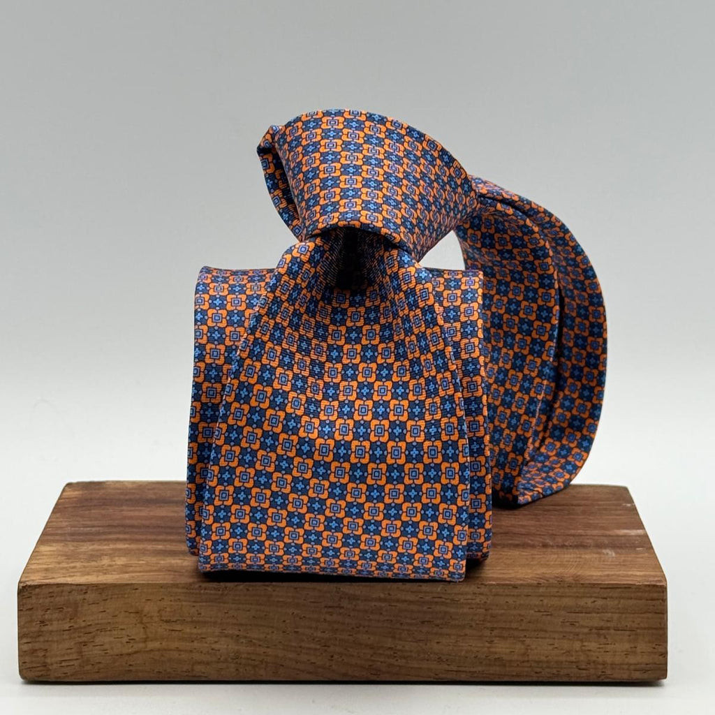 Cruciani &amp; Bella
100% Printed Silk&nbsp;
Tipped
Orange, Light Blue and Blue Motif Tie
Handmade in Italy
8,5 cm x 148 cm
New Old Stock