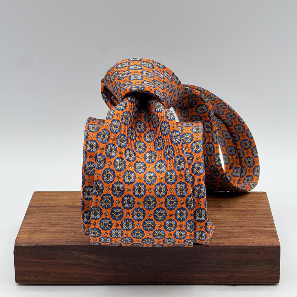 Cruciani &amp; Bella
100% Printed Silk&nbsp;
Tipped
Orange, Light Blue, Blue and Yellow Motif Tie
Handmade in Italy
8,5 cm x 148 cm
New Old Stock
