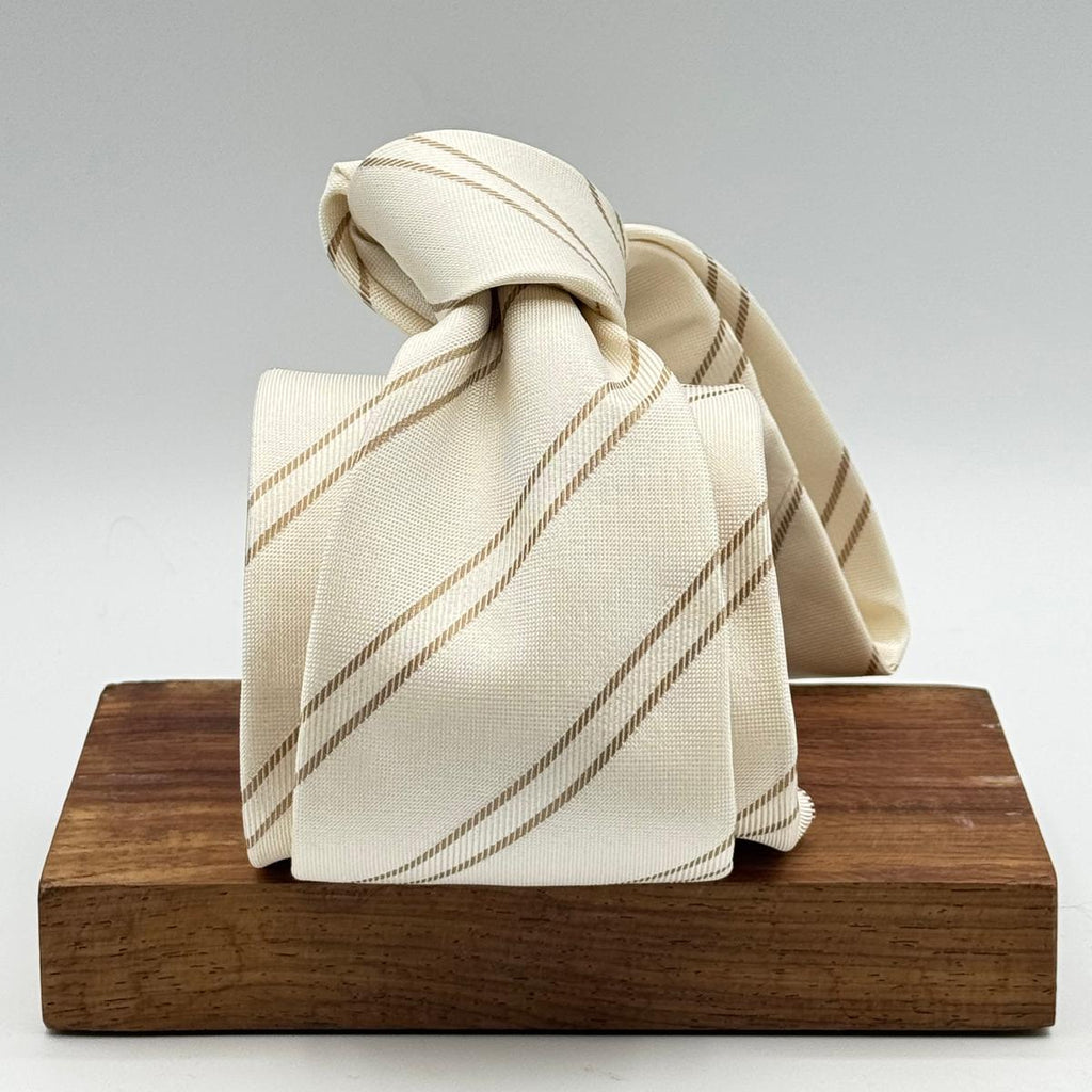 Cruciani &amp; Bella

100% Silk&nbsp;
Self Tipped
Off White and Light Brown Stripe&nbsp;
Handmade in Italy
9,5 cm x 148 cm
New Old Stock